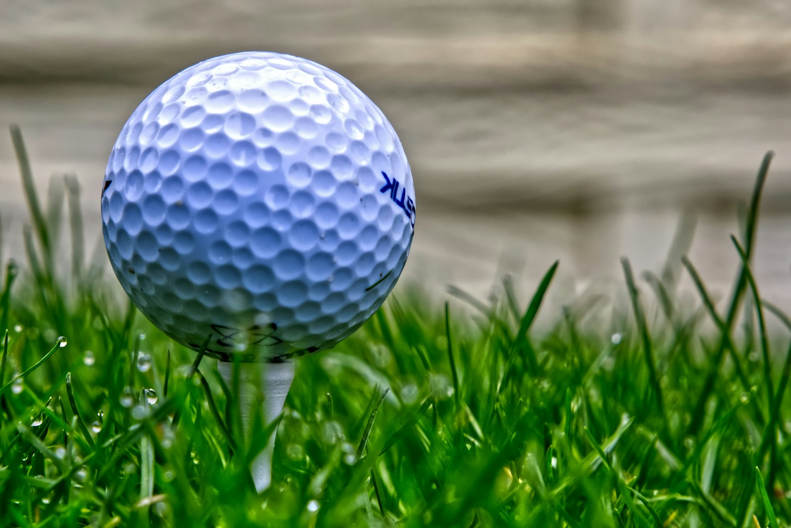 A golf ball sitting on top of a lush green field